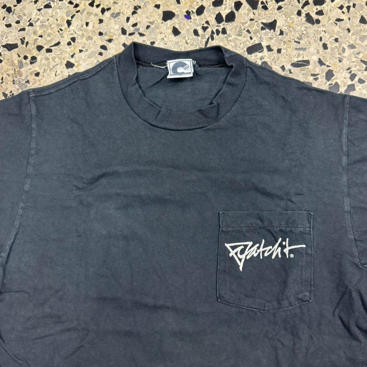 VINTAGE 90S SINGLE STITCH CATCH IT WORLD CONCERN ABSTRACT SURF POCKET TEE: